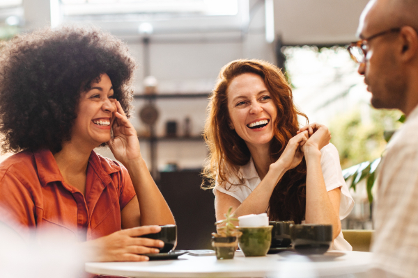 Friends Chatting At Table 600X400